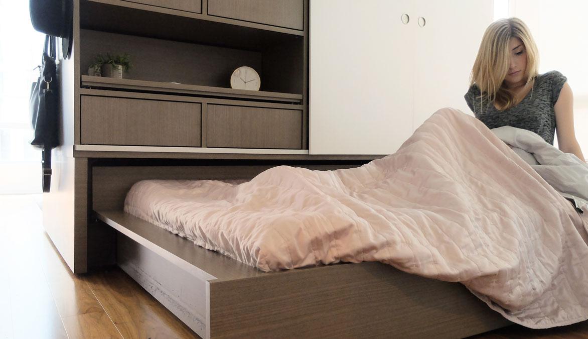 Blonde woman waking up in rolled out ORI Modular bed